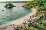 Beautiful sunset view over the ocean and palm trees at Crystal Bay Beach in Nusa Penida